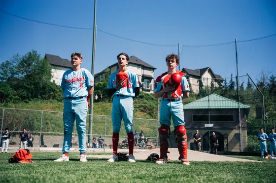 Abbotsford Cardinals players stand ready on the field before a game.