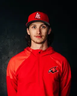Coach Berenbaum in a red Cardinals cap and hoodie.